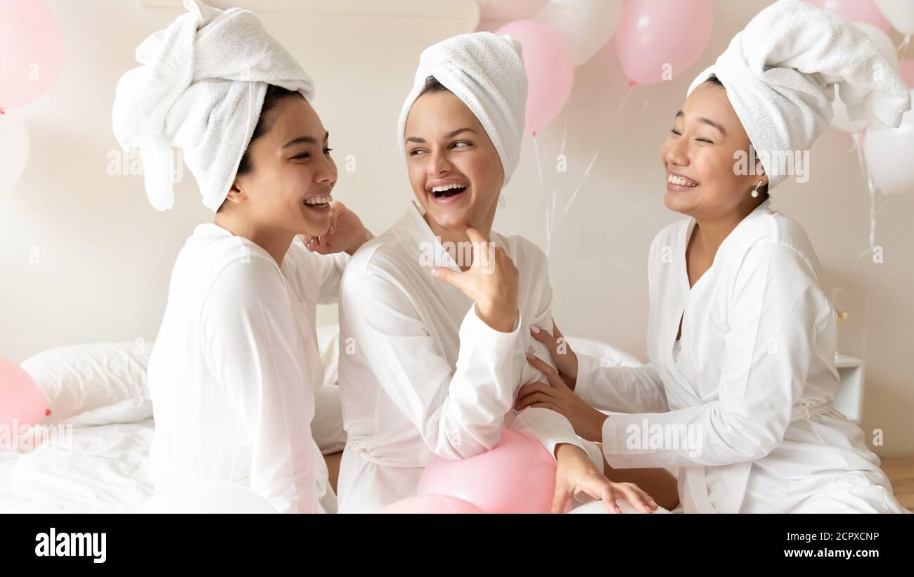 Happy beautiful bride and diverse bridesmaids preparing for wedding day. Stock Photo