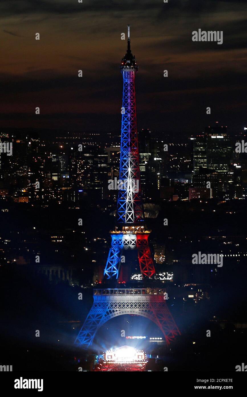 Blue, white and red lights are projected on the Eiffel Tower in a picture taken from the Montparnasse Tower Observation Deck, at the end of Day events in Paris, France, July