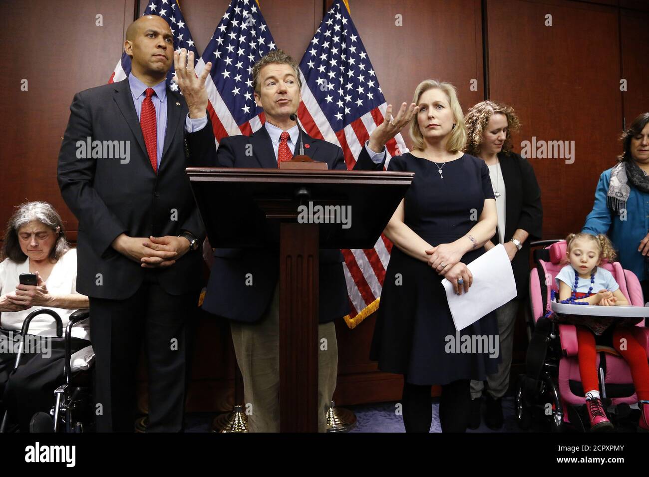 U.S. Senator Cory Booker (D-NJ) (from 2nd L), Senator Rand Paul (R-KY), and Senator Kirsten Gillibrand (D-NY) hold a news conference, to introduce legislation that would prevent the federal government from prosecuting medical marijuana users in states where it is legal, at the U.S. Capitol in Washington, March 10, 2015. Also pictured are medical marijuana patients Sandy Faiola (L) from New Jersey and Morgan Jones (bottom R), a 4-year-old Druvet syndrome sufferer from New York.   REUTERS/Jonathan Ernst    (UNITED STATES - Tags: POLITICS HEALTH SOCIETY) Stock Photo