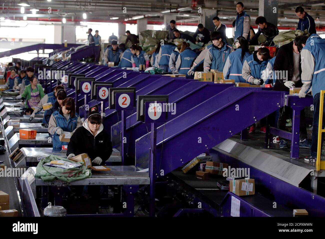 Workers sort parcels at a YTO Express logistics centre in Beijing, China, March 25, 2016. REUTERS/Jason Lee/File photo Stock Photo