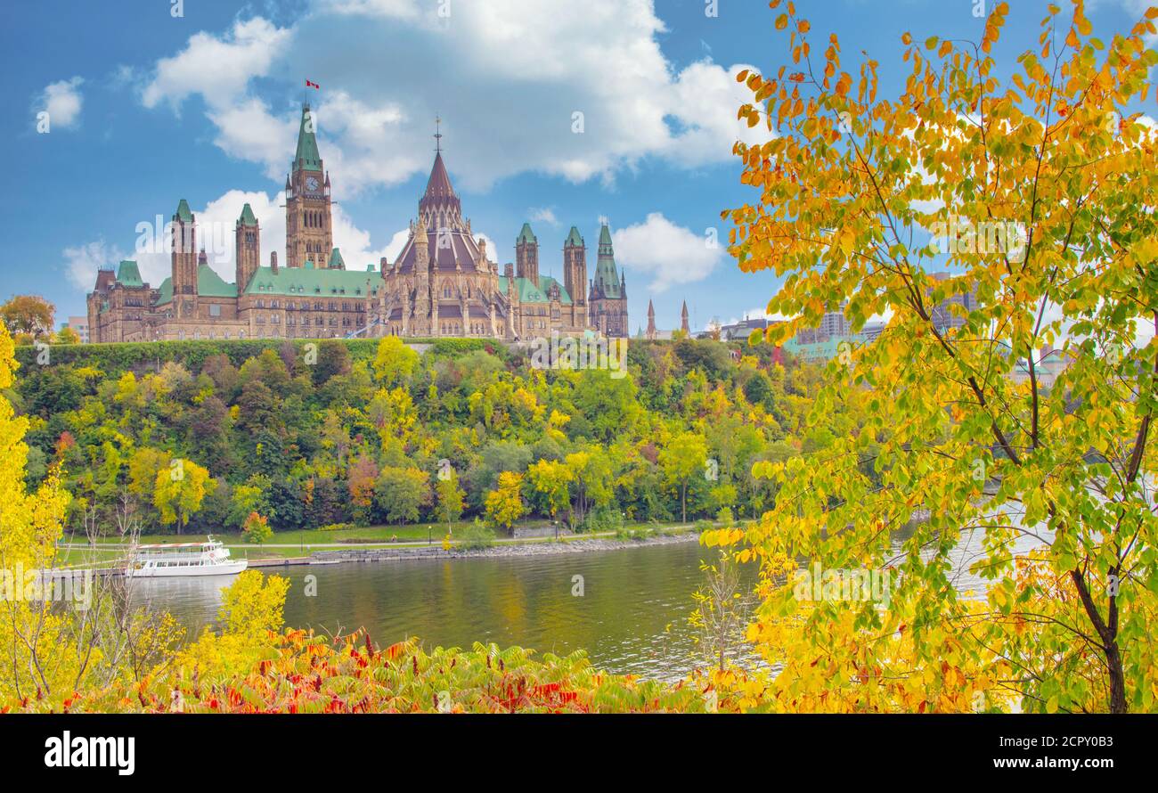 Parliament Hill with brilliant autumn foliage and reflections on Ottawa River in Ontario, Canada Stock Photo
