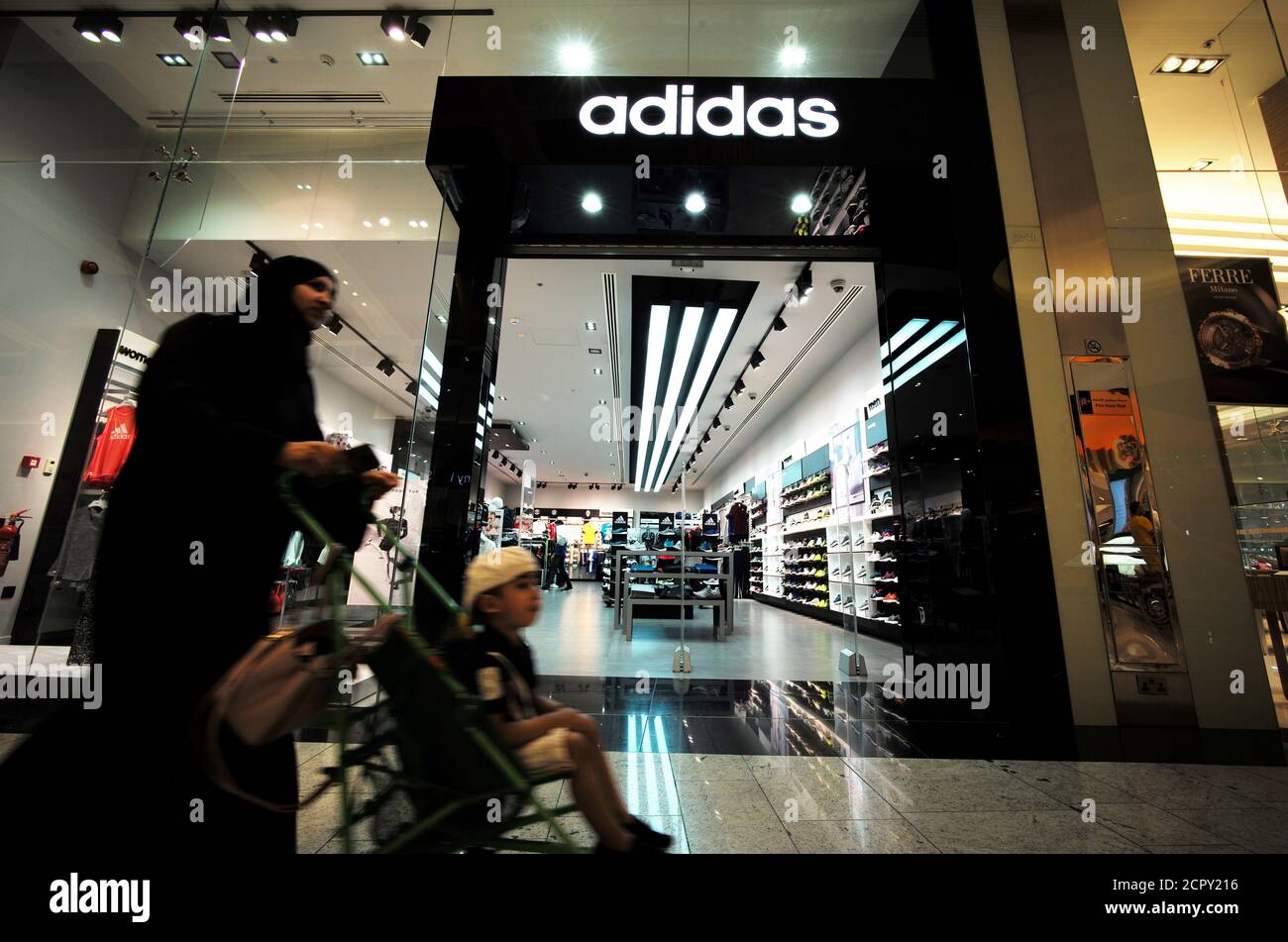 A local woman is seen pushing her baby in front of the Adidas store at  Bahrain City Center in Manama, Bahrain September 17, 2017. REUTERS/Hamad I  Mohammed Stock Photo - Alamy
