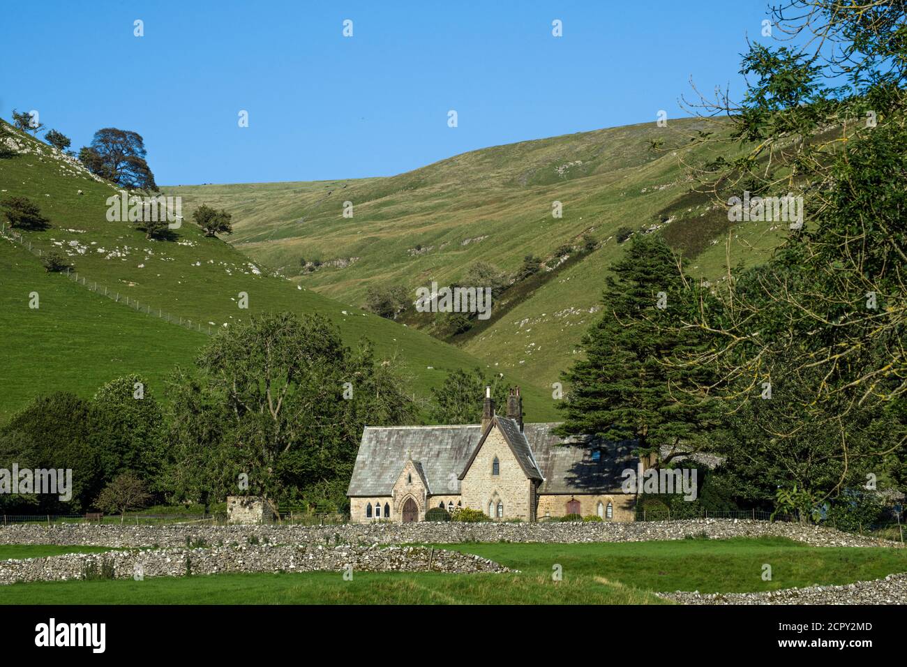 Buckden Old School House fronting Buckden Ghyll behind it, in Upper Wharfedale in the Yorkshire Dales National Park in September. Stock Photo