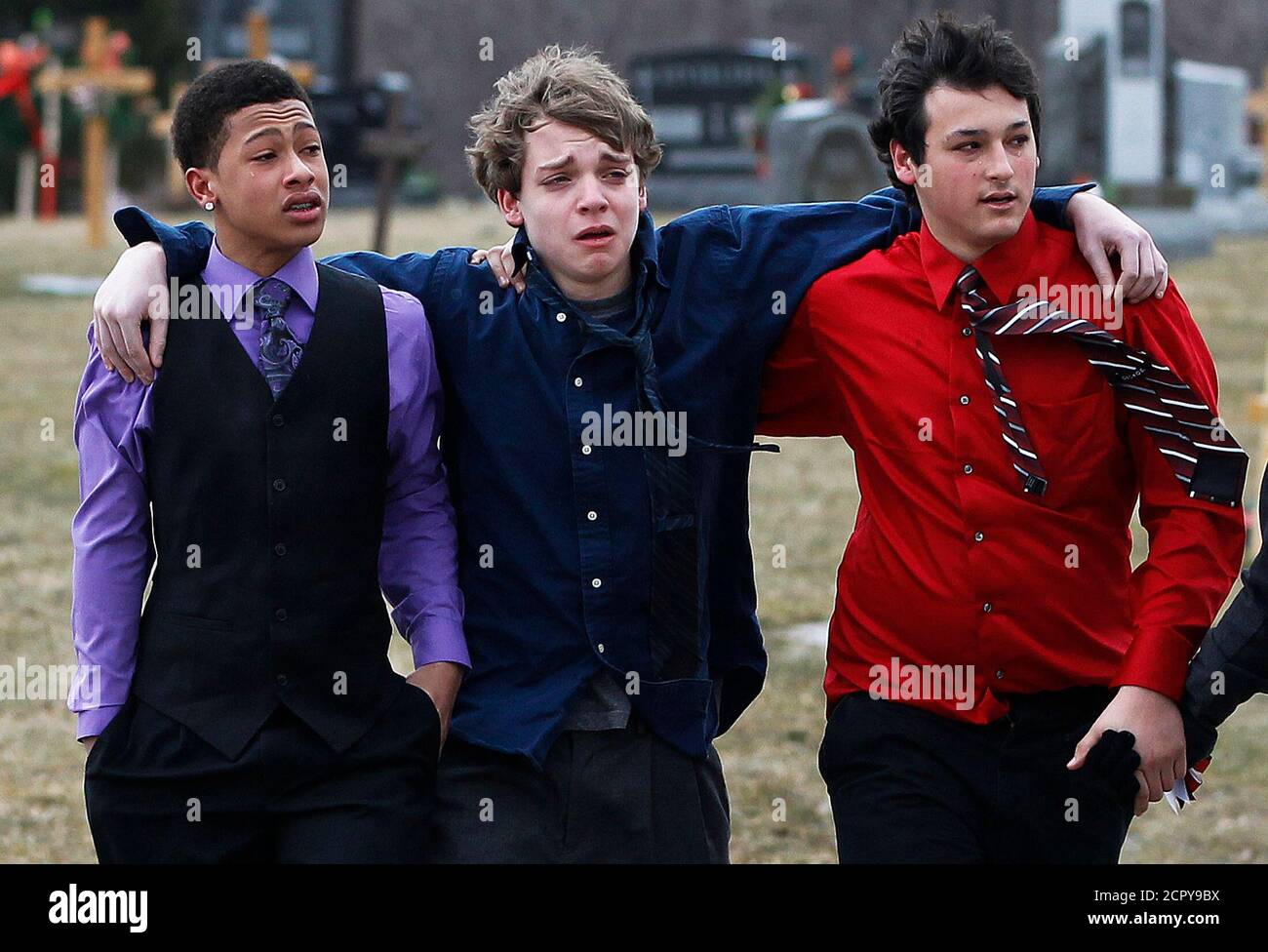 Students leave the gravesite of Chardon High School student Daniel Parmertor  after his burial in Chardon, Ohio March 3, 2012. Prosecutors in Ohio on  Thursday formally charged 17-year-old T.J. Lane with three