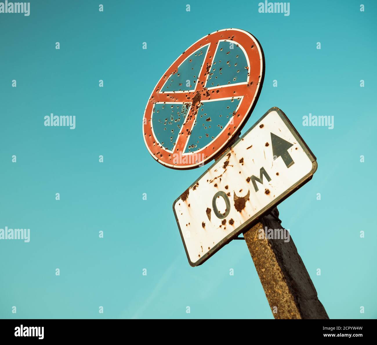 old broken roadside sign at blue sky backgroundsunlight Stock Photo