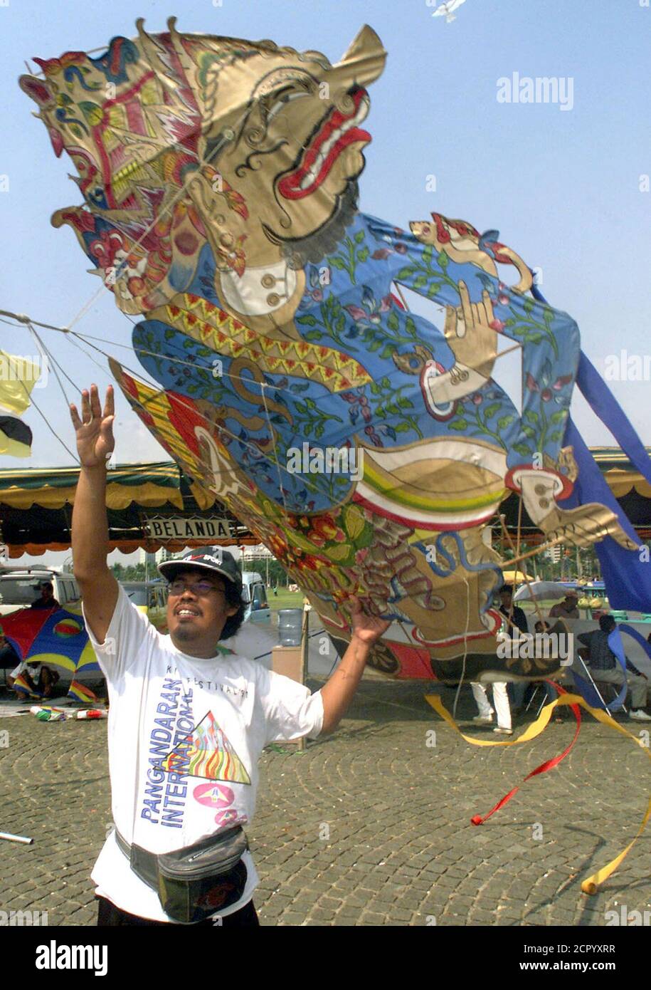 A contestant from central Java flies a kite which resembles a Indonesian shadow puppetc character at the International Kite Festival in Jakarta on July 7. Fourteen provinces in Indonesia and ten countries including Malaysia, Netherland and Japan, participated in the three day festival. PRI/TS Stock Photo