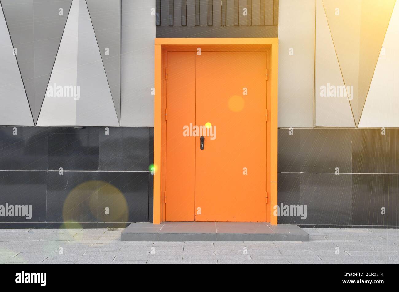 closed metal fire door in orange color. Stock Photo