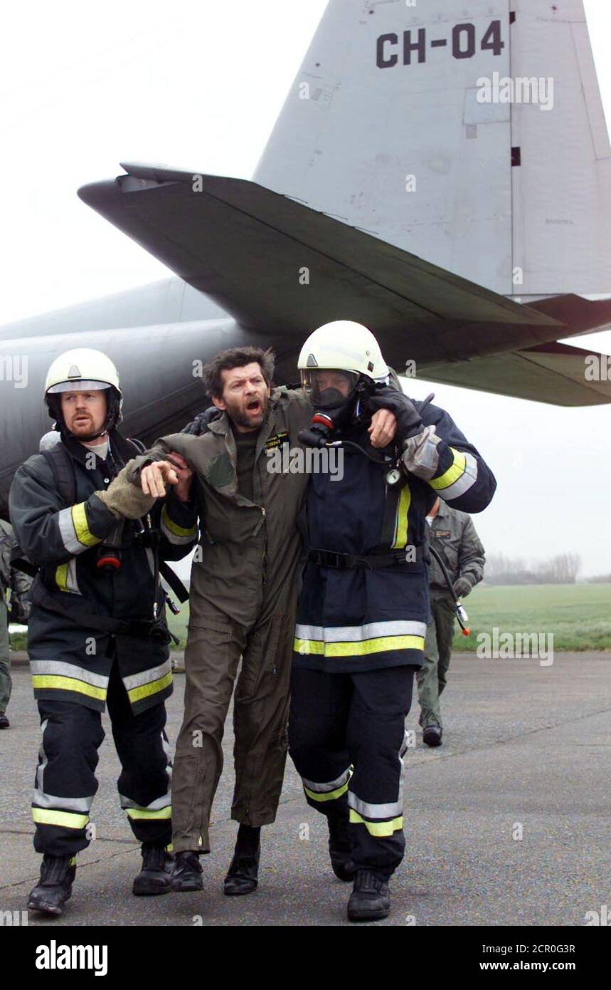 A volunteer playing the role of an injured man is evacuated by firemen during the reconstruction of an emergency plan set up after an aeroplane crash in Koksijde, northern Belgium March 14. These exercises are frequently organised to prevent mistakes in the evacuation of victims.  HRM Stock Photo
