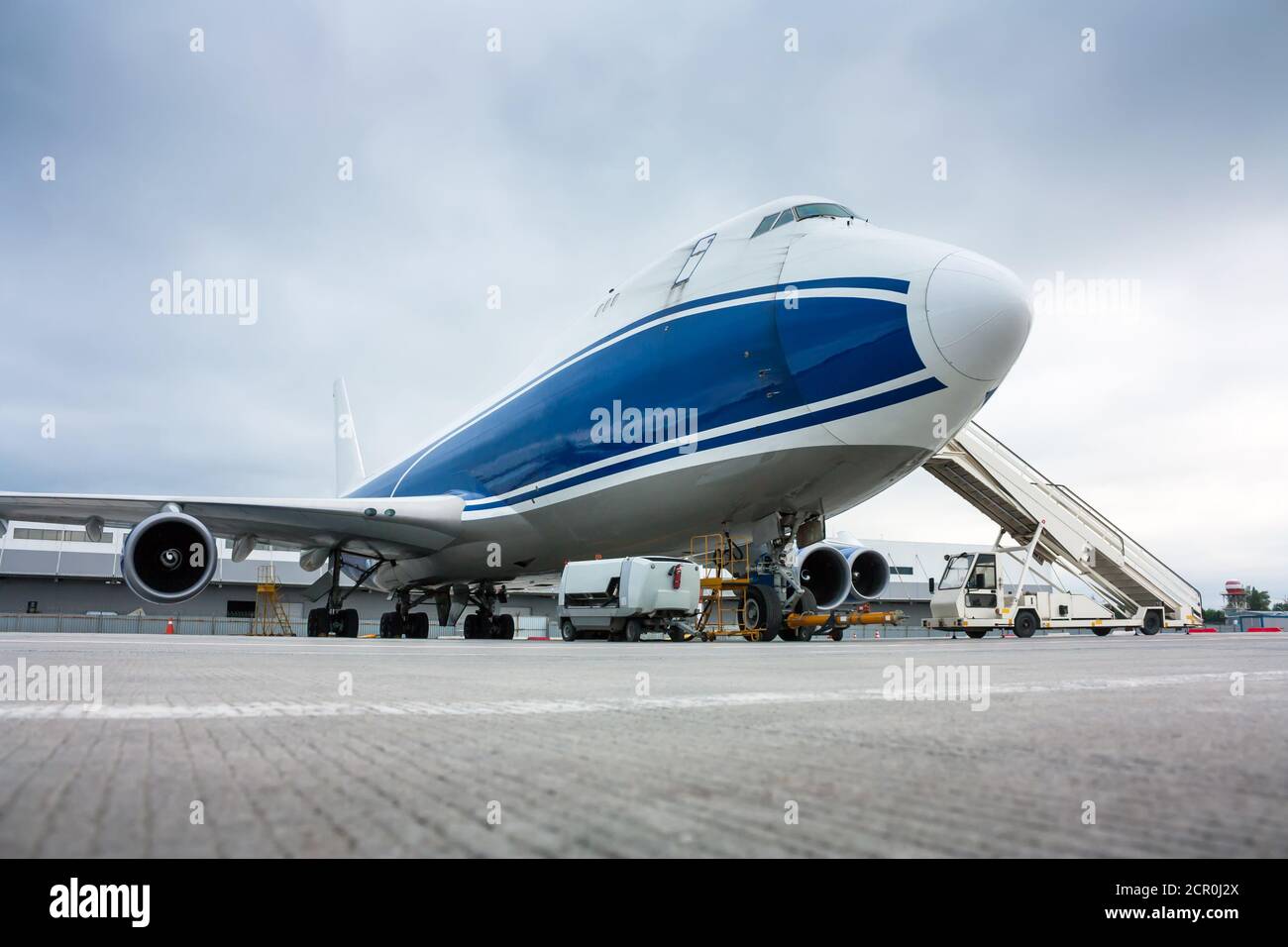 Cargo wide-body plane and aircraft passenger loader near terminal Stock Photo