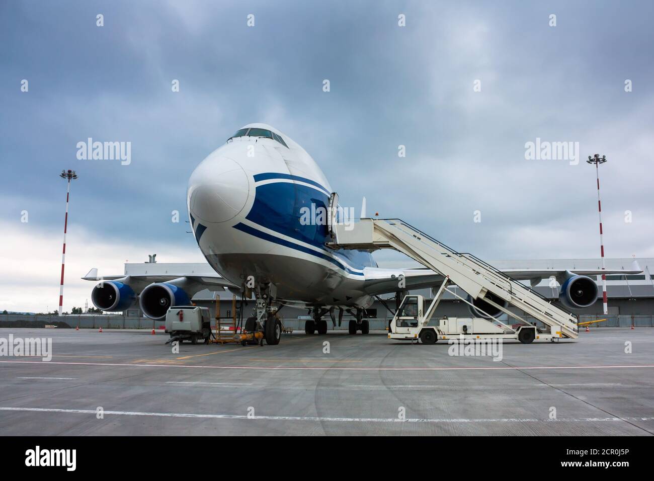 Cargo wide body plane and aircraft passenger loader near terminal Stock Photo