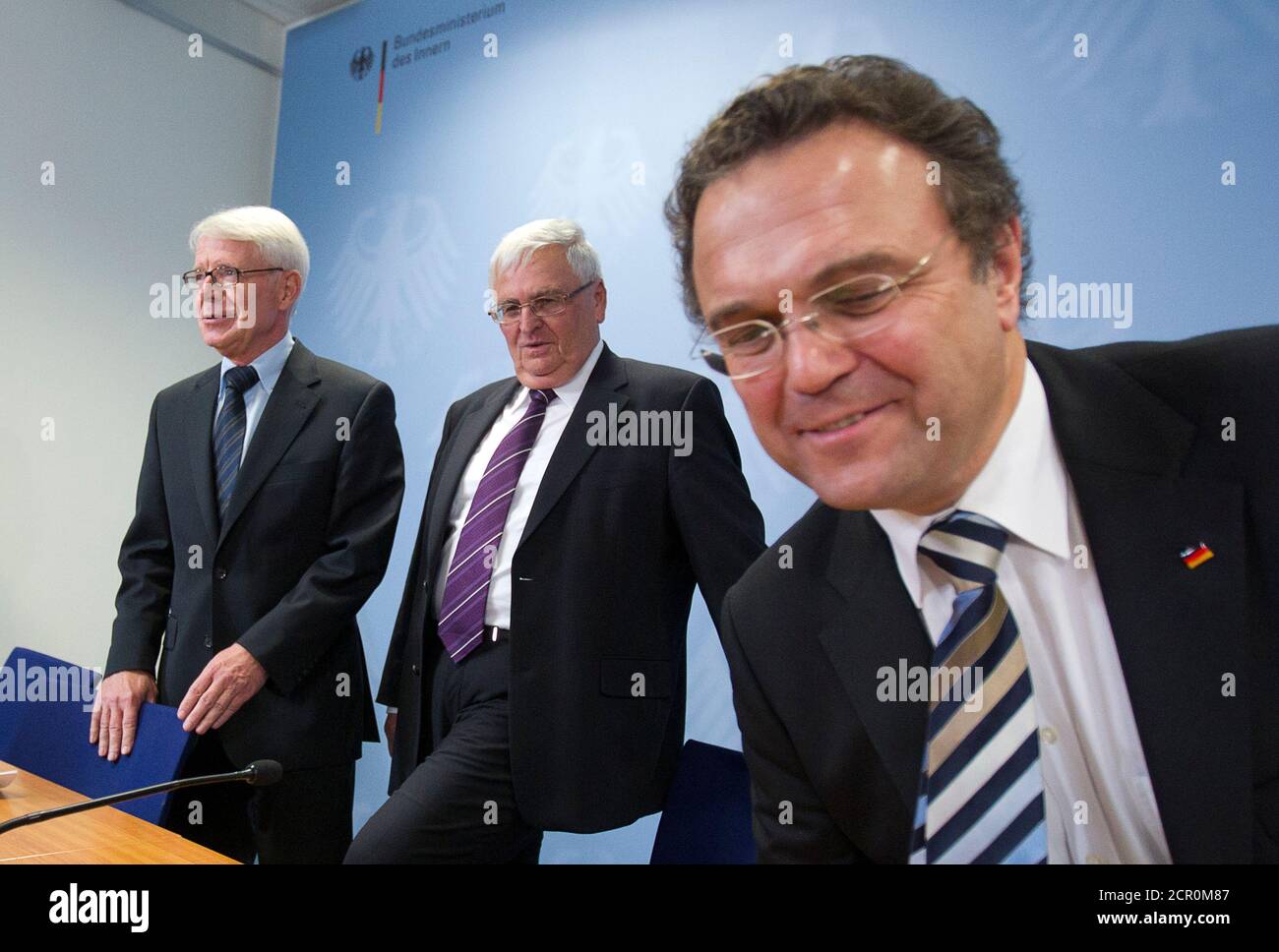 German Interior Minister Hans-Peter Friedrich (R) and President of the German Football Association (DFB),Theo Zwanziger (2nd R), and German Soccer League President Reinhard Rauball arrive at a news conference after a round table on violence during and after soccer matches, in Berlin November 14, 2011.  REUTERS/Thomas Peter (GERMANY) Stock Photo