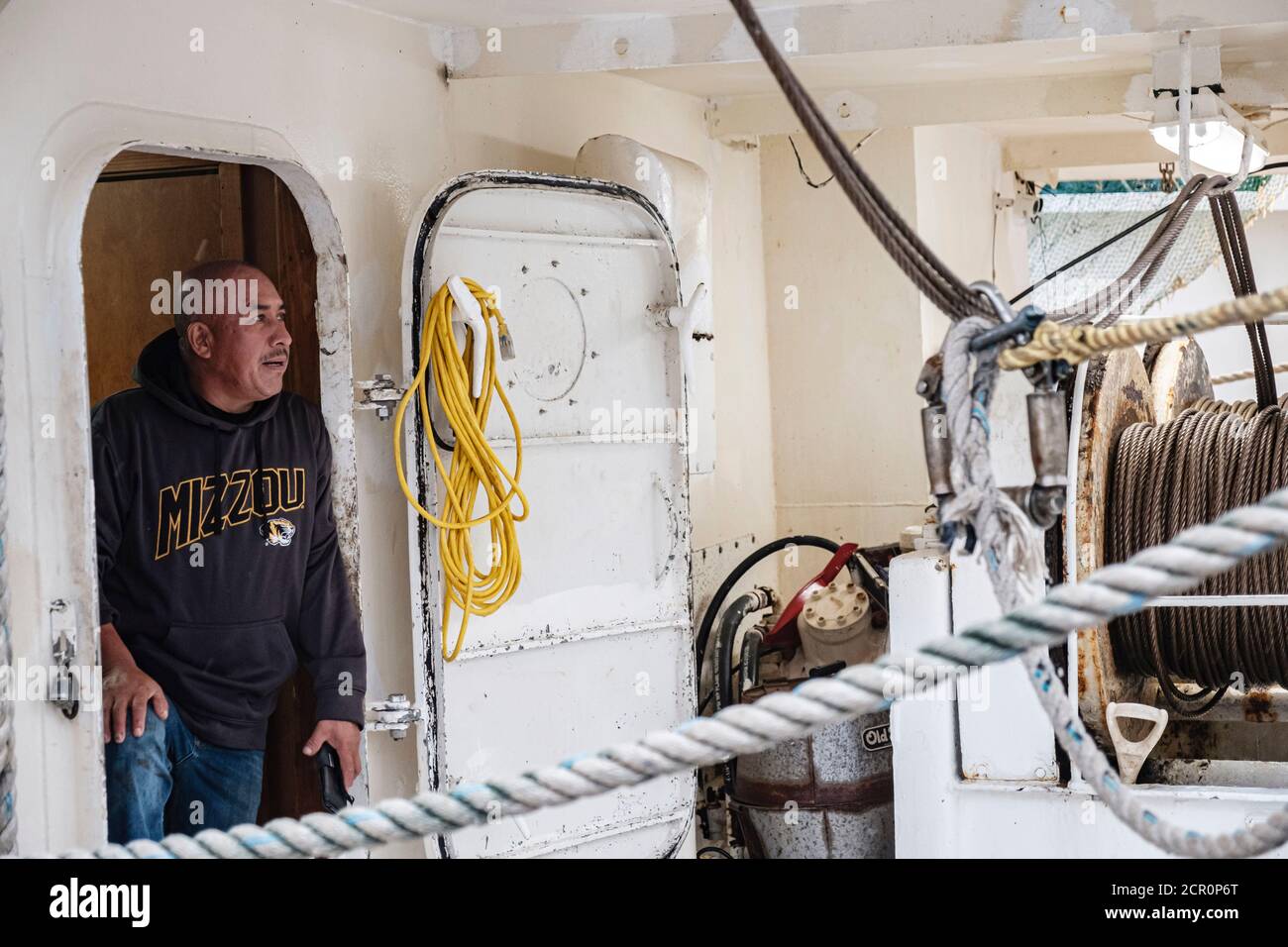 Bayou La Batre, ALABAMA, USA. 15th Sep, 2019. A man looks out from his fishing boat as Hurricane Sally pushes rain and wind into Bayou La Batre, Alabama USA on September 15, 2020. Hurricane Sally is predicted to make landfall as a Category 2 Hurricane. Credit: Dan Anderson/ZUMA Wire/Alamy Live News Stock Photo