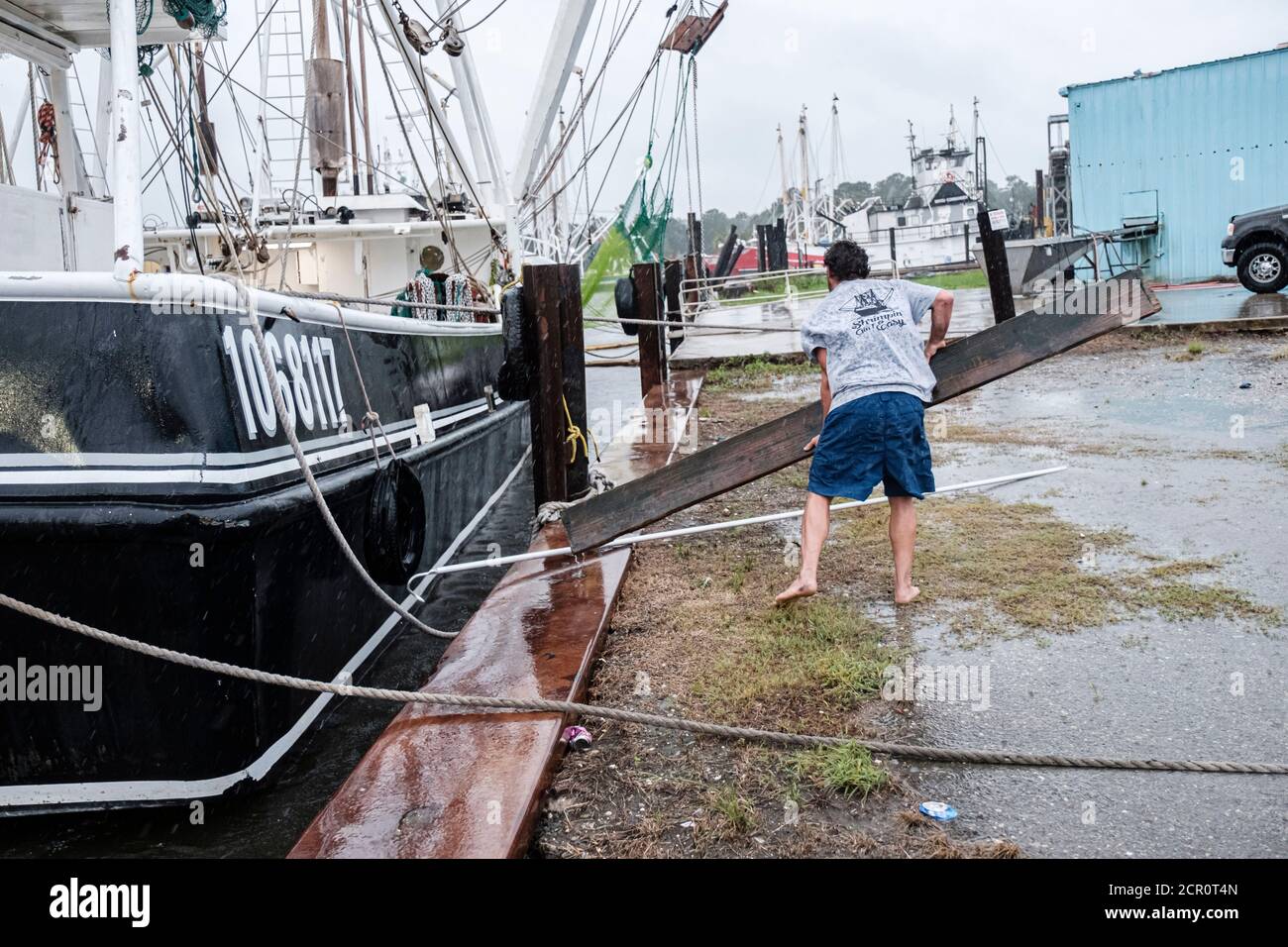 Bayou La Batre, ALABAMA, USA. 15th Sep, 2019. Forrest Collier tries to get onboard his fishing boat The Emily Ariel while Hurricane Sally pushes wind and rain into Bayou La Batre, Alabama USA on September 15, 2020. Hurricane Sally is predicted to make landfall as a Category 2 Hurricane. Credit: Dan Anderson/ZUMA Wire/Alamy Live News Stock Photo
