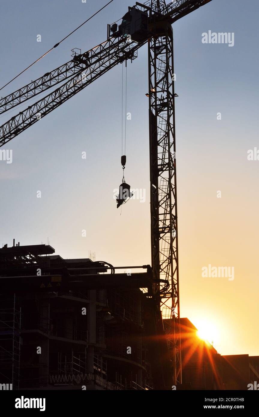 Crane on a construction site at sunset Stock Photo