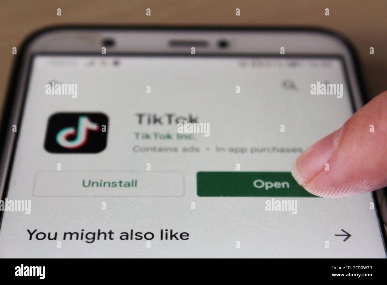 https://c8.alamy.com/comp/2CR0W7R/a-finger-pressing-the-open-button-for-tiktok-from-the-google-play-store-after-downloading-the-app-2CR0W7R.jpg