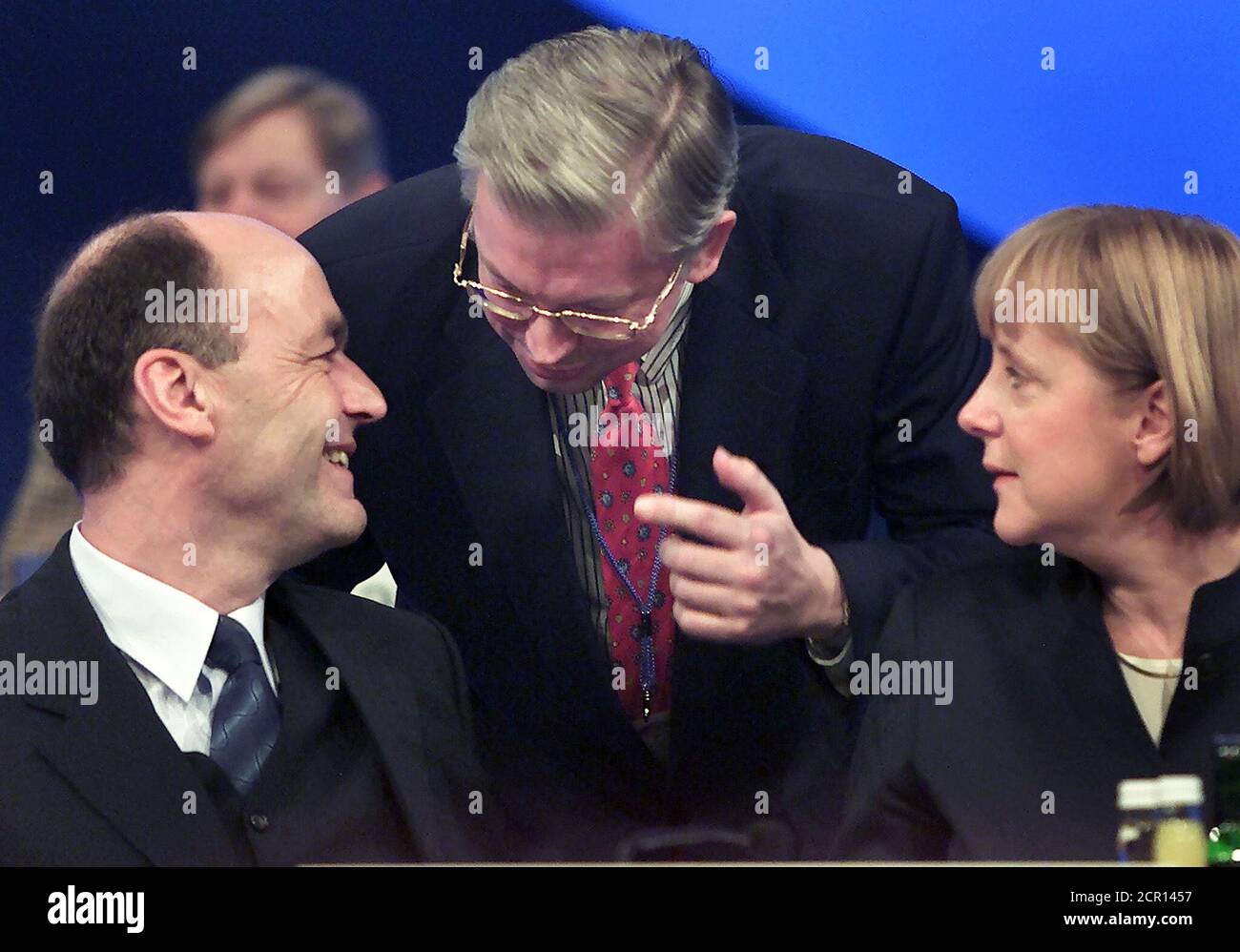 Laurenz Meyer (L), secretary general of the conservative Christian Democratic Union (CDU) and party leader Angela Merkel listen to Hesse's Prime Minister Roland Koch during the 14th general party meeting of the CDU in Dresden, December 3, 2001. The conservatives, struggling to rebuild their party after a funding scandal around former chancellor Helmut Kohl and trailing behind Schroeder in the polls, said the event will focus on immigration and Social Democratic Chancellor Schroeder's failure to cut unemployment. REUTERS/Arnd Wiegmann  KP/WS Stock Photo
