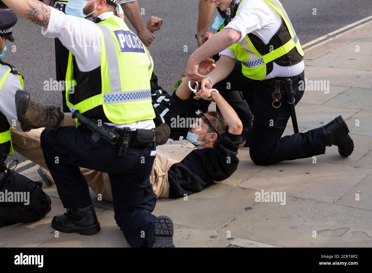 Arrested protester handcuffed on ground outside Parliament, Extinction Rebellion demonstration, London, 10 September 2020 Stock Photo