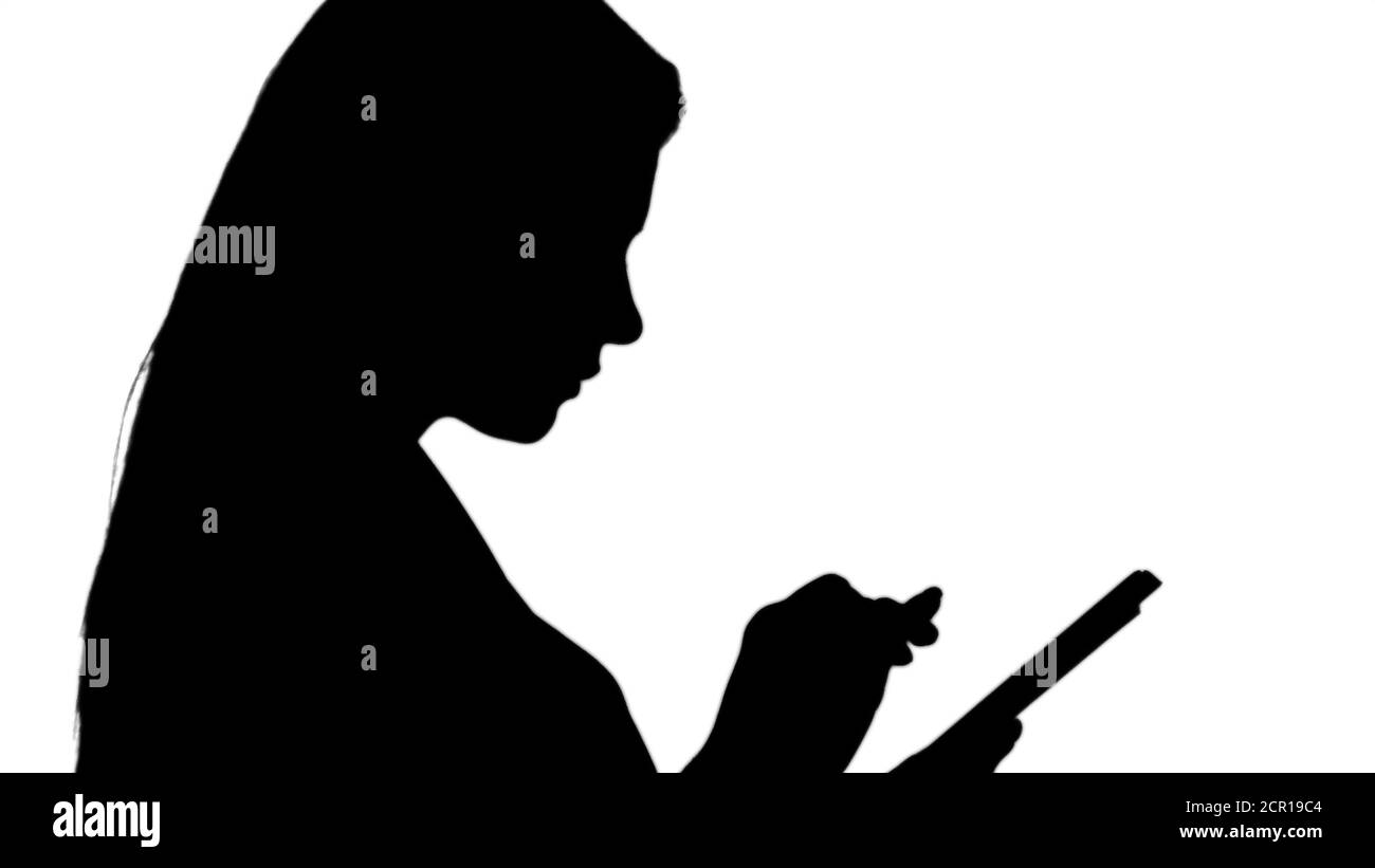 Silhouette Pleasant woman using tablet. Stock Photo