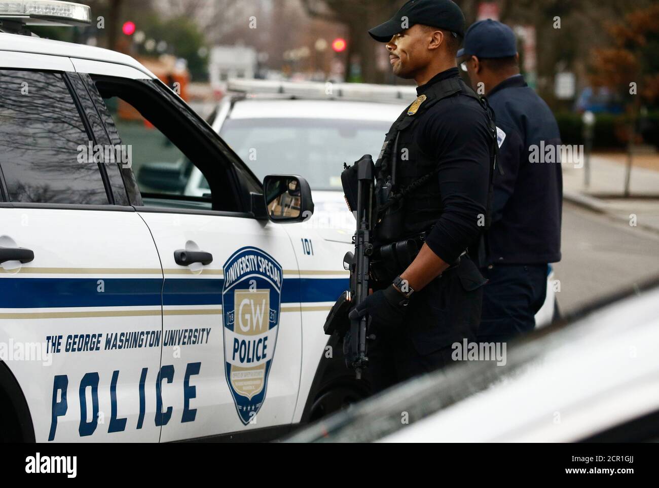 Security officers stand watch after a passenger vehicle struck a security barrier near the White House in Washington, U.S., February 23, 2018. REUTERS/Jim Bourg Stock Photo