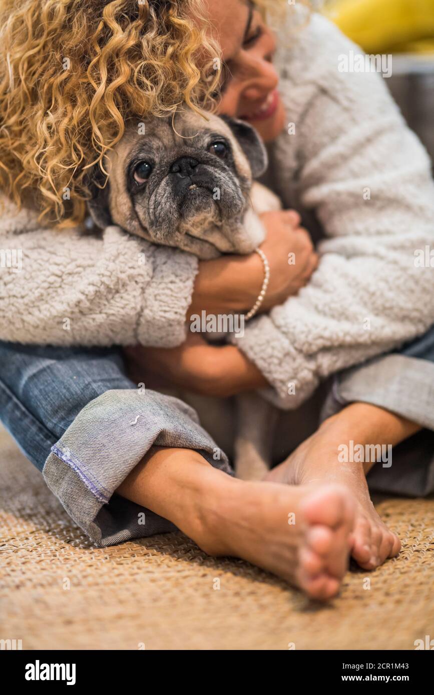 Lovely hug human and animal for pet therapy or domestic dog love and kind  woman at home - real scene adult lady and old domestic puppy hugging and  Stock Photo - Alamy