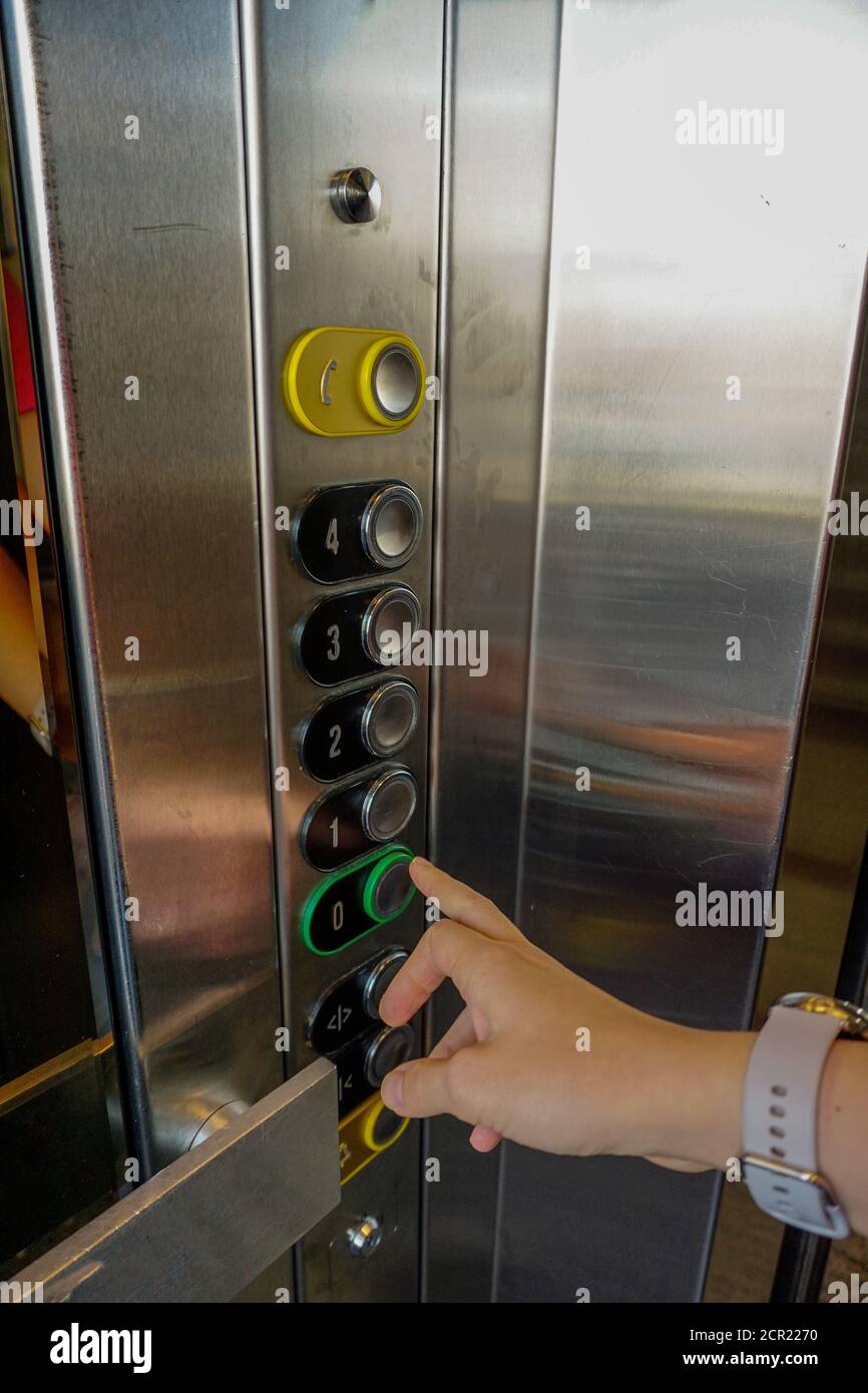 Woman hand on the elevator button close up view Stock Photo
