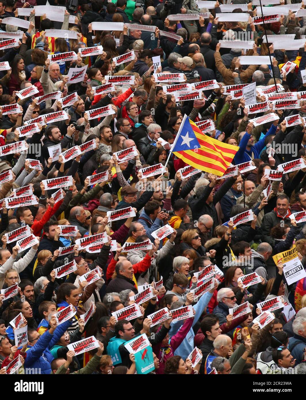 Protesters hold banners reading 'Freedom Political Prisoners, We are Republic' as they gather in Sant Jaume square at a demonstration during a partial regional strike in Barcelona, Spain, November 8, 2017.  REUTERS/Albert Gea Stock Photo