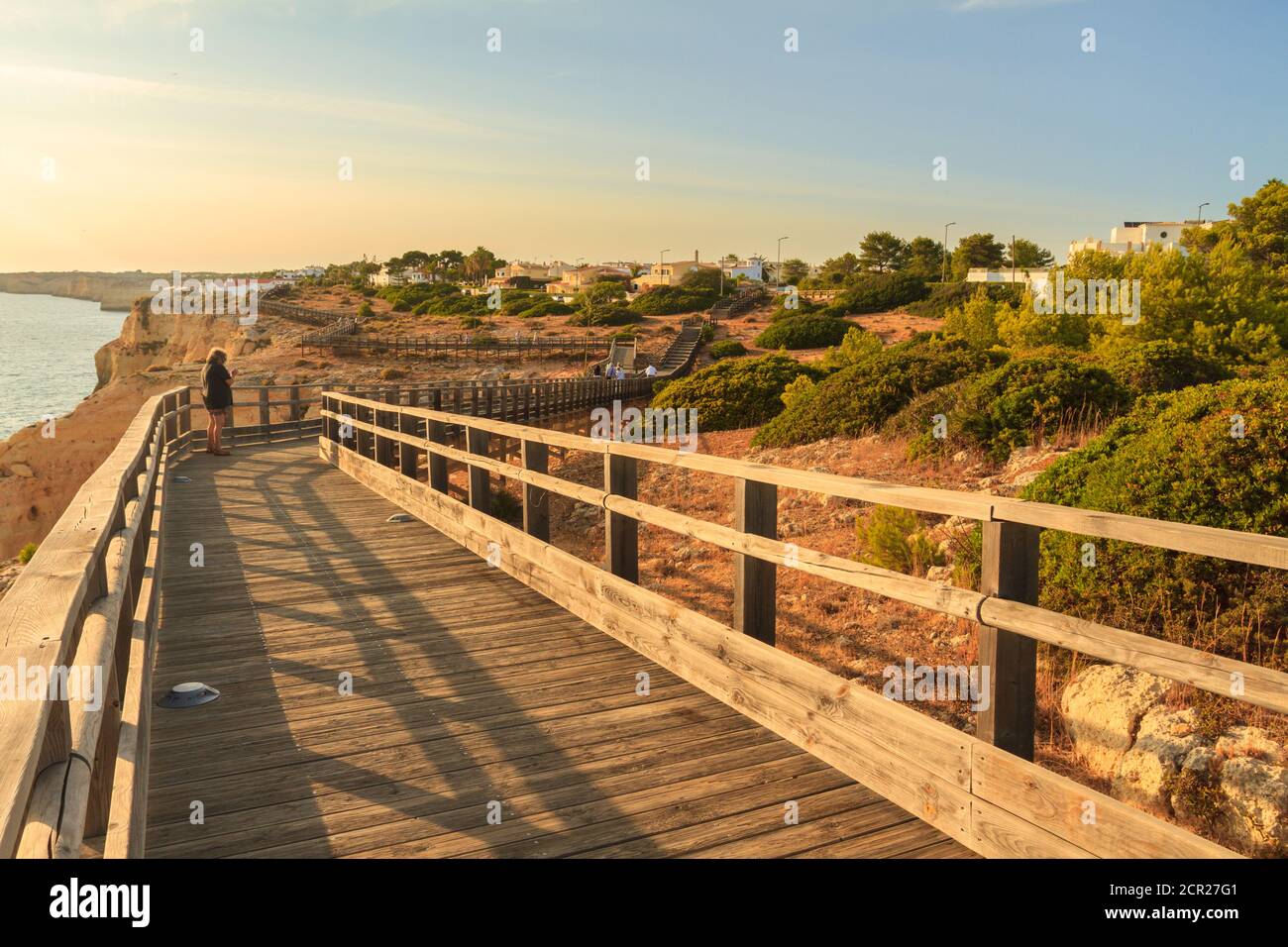 Carvoeiro boardwalk during sunset. A scenic cliff top walk alongside Algar Seco rock formation, Algarve, Portugal. Stock Photo