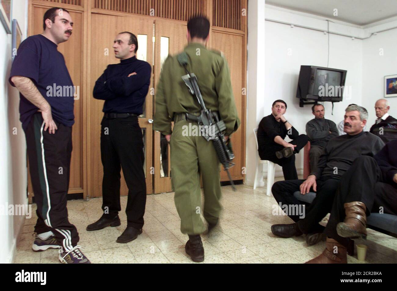 An Israeli soldier walks through a room containing Russian passengers of a hijacked Russian Tupolev 154 commercial passenger plane in the Israeli military section at the Uvda air base in the Negev Desert north of Eilat November 12, 2000. Israeli security forces on Sunday seized a Chechen man who hijacked a Russian airliner to Israel and all 58 passengers and crew members left the plane safely, the army chief of staff said.  JWH/CRB Stock Photo