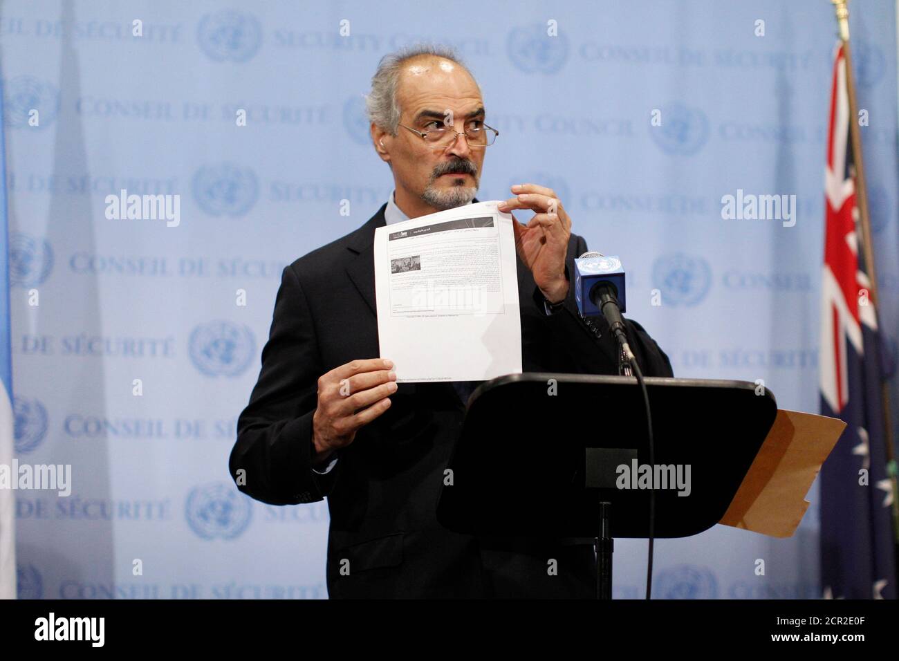 Syrian U.N. Ambassador Bashar Ja'afari shows a document to reporters at the United Nations Headquarters in New York, September 12, 2013. Syria became a full member of the global anti-chemical weapons treaty on Thursday, Ja'afari said, a move that the government of Syrian President Bashar al-Assad had promised as part of a deal to avoid U.S. air strikes.   REUTERS/Brendan McDermid (UNITED STATES - Tags: POLITICS TPX IMAGES OF THE DAY) Stock Photo