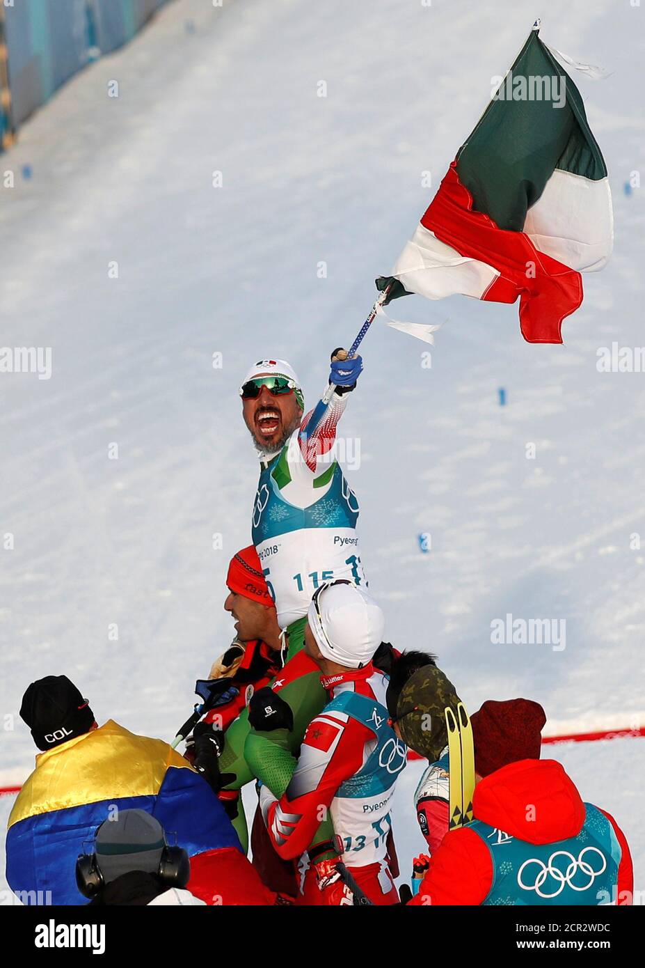 Cross-Country Skiing – Pyeongchang 2018 Winter Olympics – Men's 15km Free – Alpensia Cross-Country Skiing Centre – Pyeongchang, South Korea – February 16, 2018 - German Madrazo of Mexico holds the Mexican flag after crossing the finish line. REUTERS/Murad Sezer     TPX IMAGES OF THE DAY Stock Photo