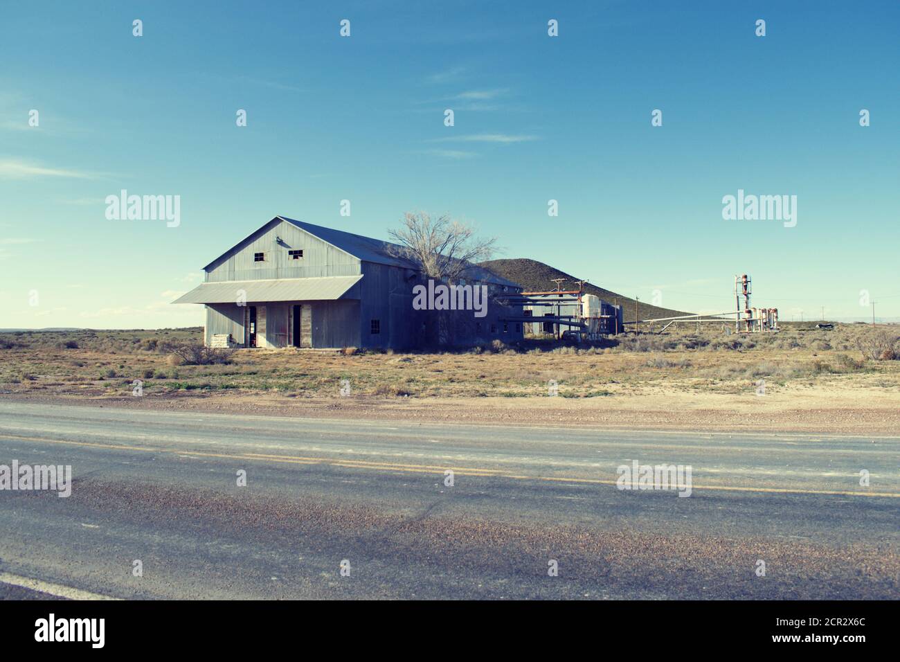 Rundown factory building by the highway along Dell City Texas Stock