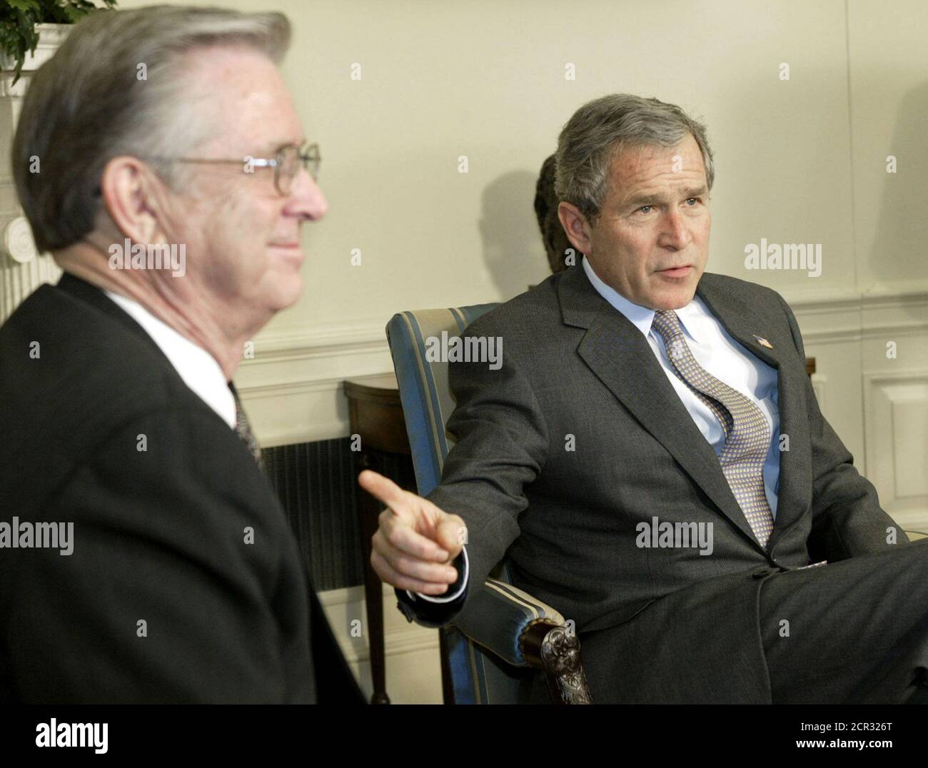 File photo of U.S. President George W. Bush pointing toward U.S. Appeals Court nominee Charles Pickering during a meeting at the White House, March 6, 2002. Frustrated at Democratic blocking maneuvers, President Bush bypassed the Senate on Friday and installed controversial nominee Pickering on the federal appeals court, sources said. The sources, who asked to remain unidentified, said a White House announcement that Pickering had been made a 'recess appointment' to the 5th Circuit Court of Appeals would be issued later. Democrats who have held up Pickering's nomination say he is part of Bush' Stock Photo