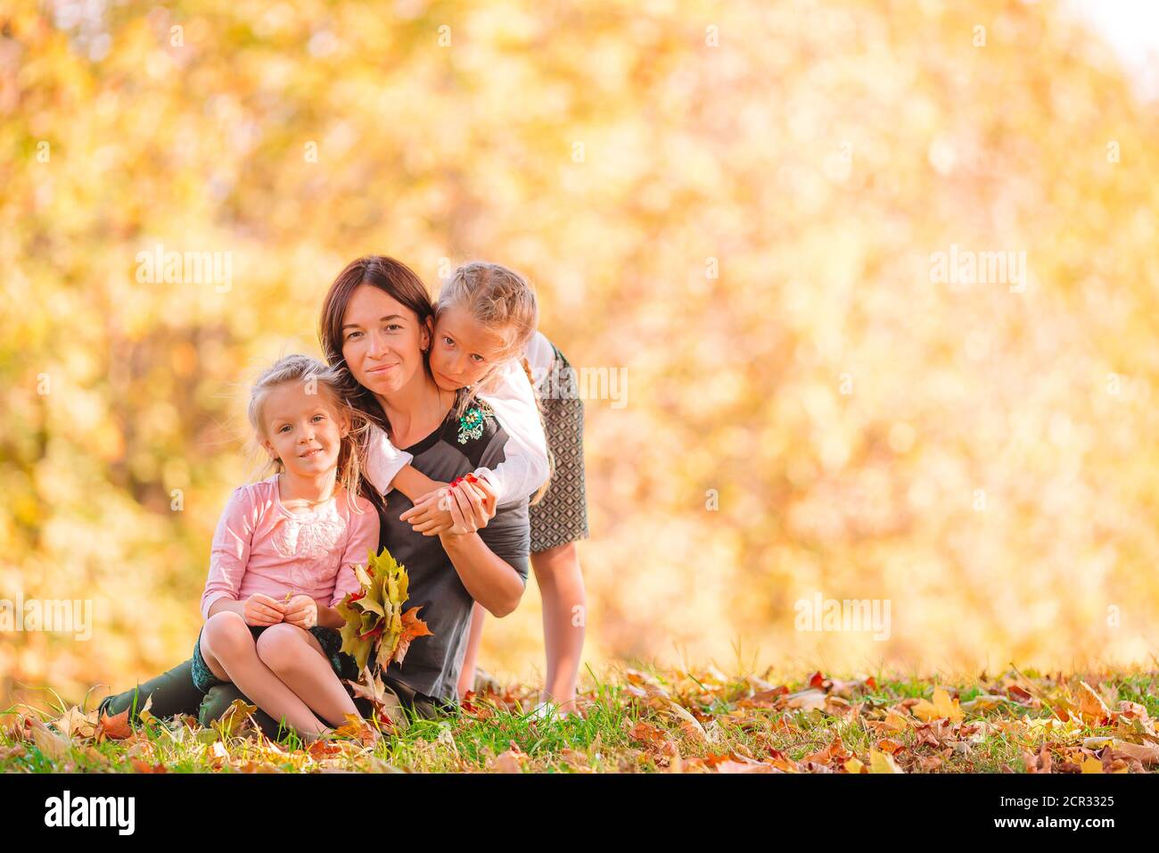 Little girl with mom outdoors in park at autumn day Stock Photo - Alamy