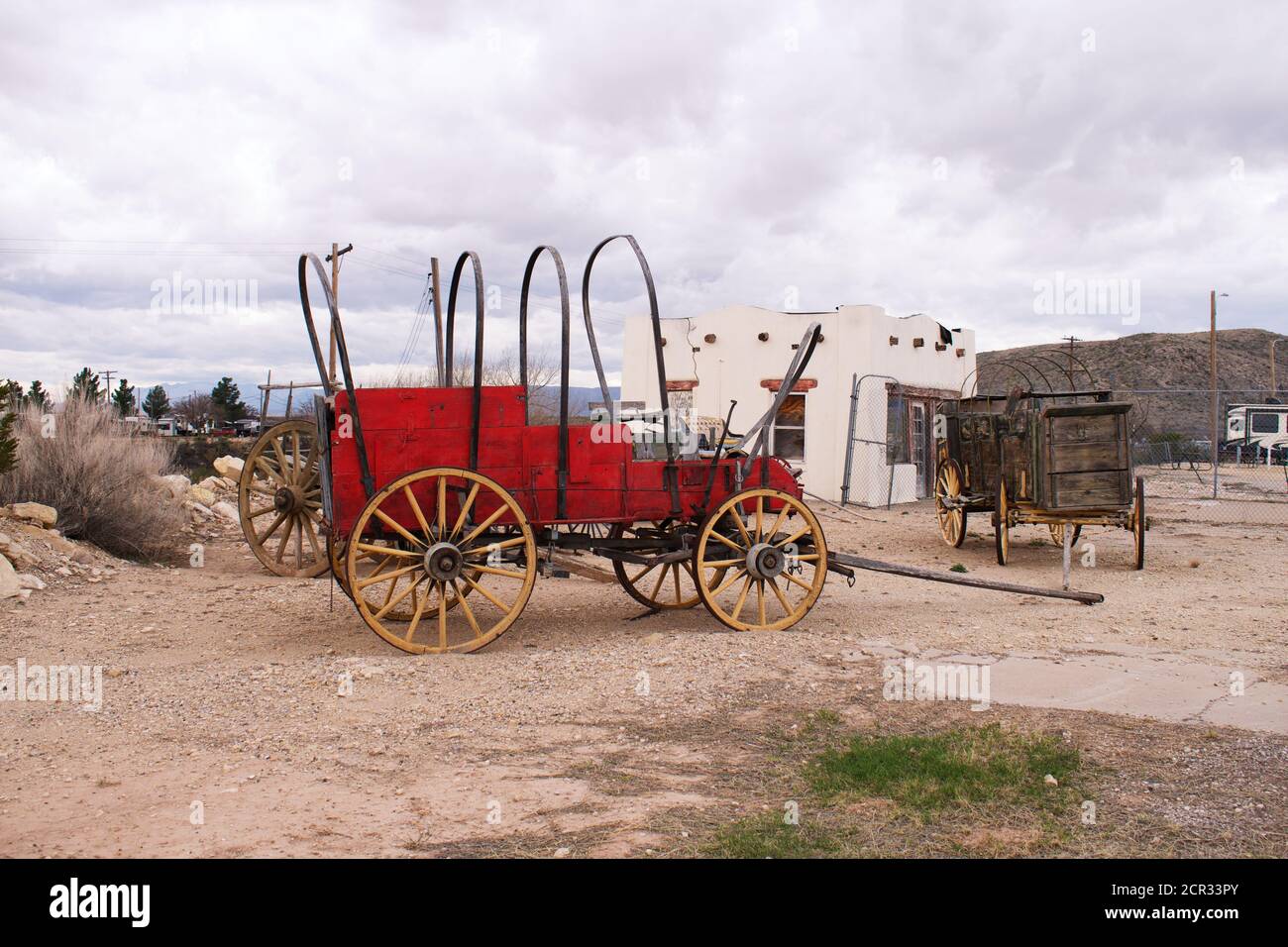 Old fashion horse-drawn wood Stage Coach or covered wagon in the desert ...