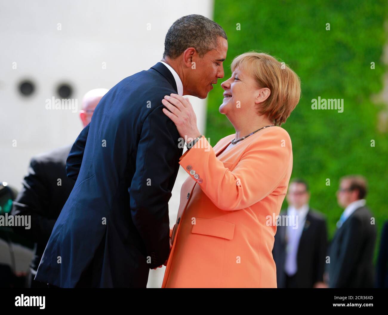 U.S. President Barack Obama embraces German Chancellor Angela Merkel outside the Chancellery in Berlin, June 19, 2013. Obama will unveil plans for a sharp reduction in nuclear warheads in a landmark speech at the Brandenburg Gate on Wednesday that comes 50 years after John F. Kennedy declared 'Ich bin ein Berliner' in a defiant Cold War address.    REUTERS/Thomas Peter (GERMANY  - Tags: POLITICS) Stock Photo