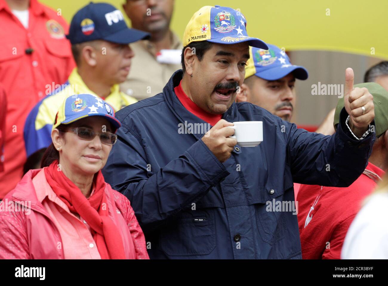 Venezuela's President Nicolas Maduro gestures during a rally to commemorate May Day, next to his wife and deputy of Venezuela's United Socialist Party (PSUV) Cilia Flores, in Caracas, Venezuela, May 1, 2016. REUTERS/Marco Bello Stock Photo