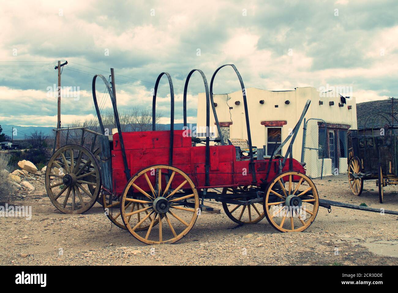 Old fashion horse-drawn wood Stage Coach or covered wagon in the desert ...
