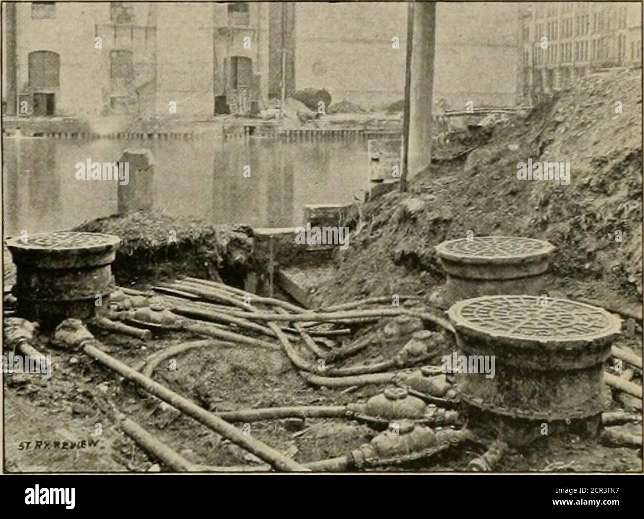 . The street railway review . 4 by 30-inch stroke. They runat 160 pounds steam pressure and carry two 200-kilo-. WIIERE THE FEEDERS REAPPEAR OPPOSITE THE POWER HOUSE. watt dynamos each. They run at 120 r. p. m. and stand21 feet high. The floor space of the room is 100 by 45feet and the engine room is 34 J4 feet high. The boiler plant consists of 18 Galoway boilers, madeby the Edge Moor people, of Delaware. These boilersare arranged in two batteries, of 9 each, one atjove theother. How it was done is shown in our engraving. Stock Photo