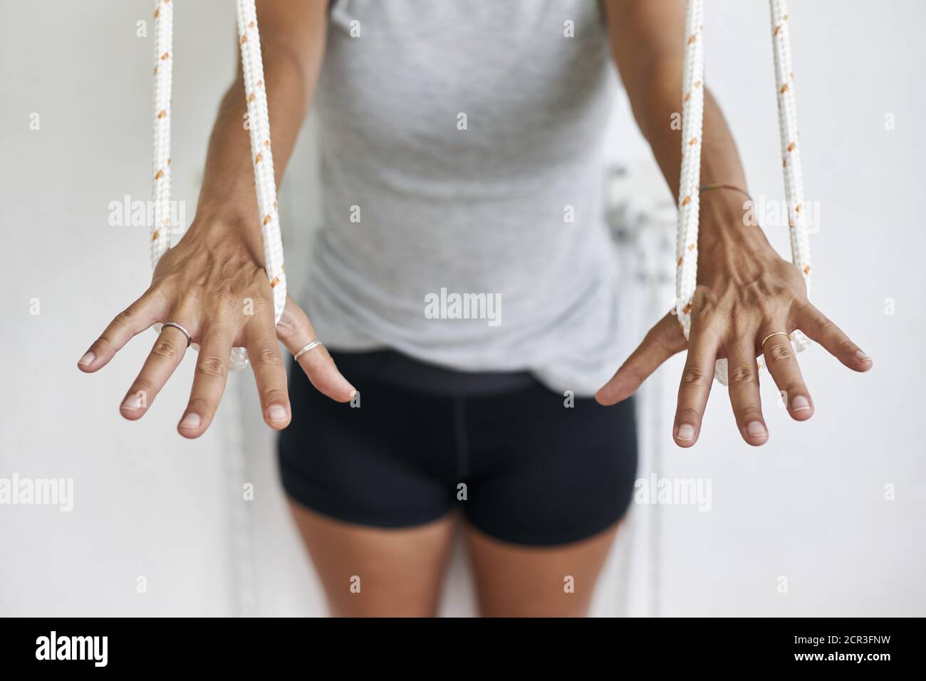 Hand Rope Exercise Closeup hands holding the rope, iyengar yoga at studio, stretching with ...