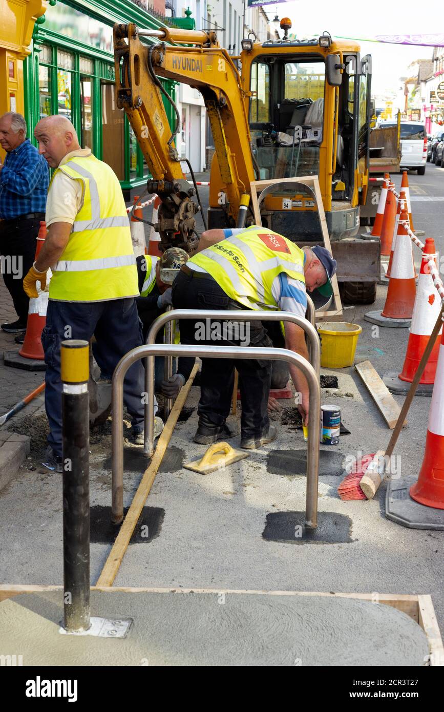 Street works for new bike racks as council workers working on bicycle parking stands installation on High Street in Killarney County Kerry Ireland Stock Photo