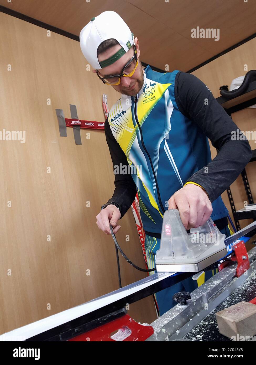 Wax technician Paul Moore of the Australian cross-country ski team works on a set of skis during the Pyeongchang 2018 Winter Olympics, in Pyeongchang, South Korea, February 20, 2018. Picture taken February 20, 2018. REUTERS/Philip O'Connor Stock Photo