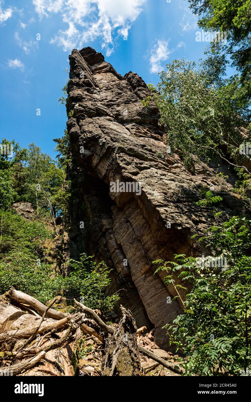 Mighty rock juts out into the blue sky. Stock Photo