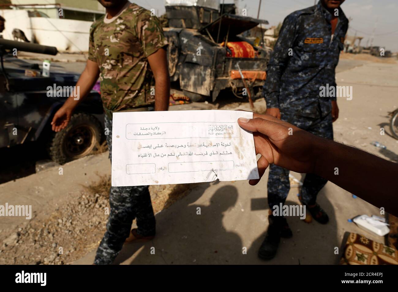 An Iraqi soldier shows an envelope which reads 'Islamic State can be entrusted to deliver your God given right of charity from the rich', along a street of the town of al-Shura, which was recaptured from Islamic State (IS) on Saturday, south of Mosul, Iraq October 30, 2016. REUTERS/Zohra Bensemra Stock Photo
