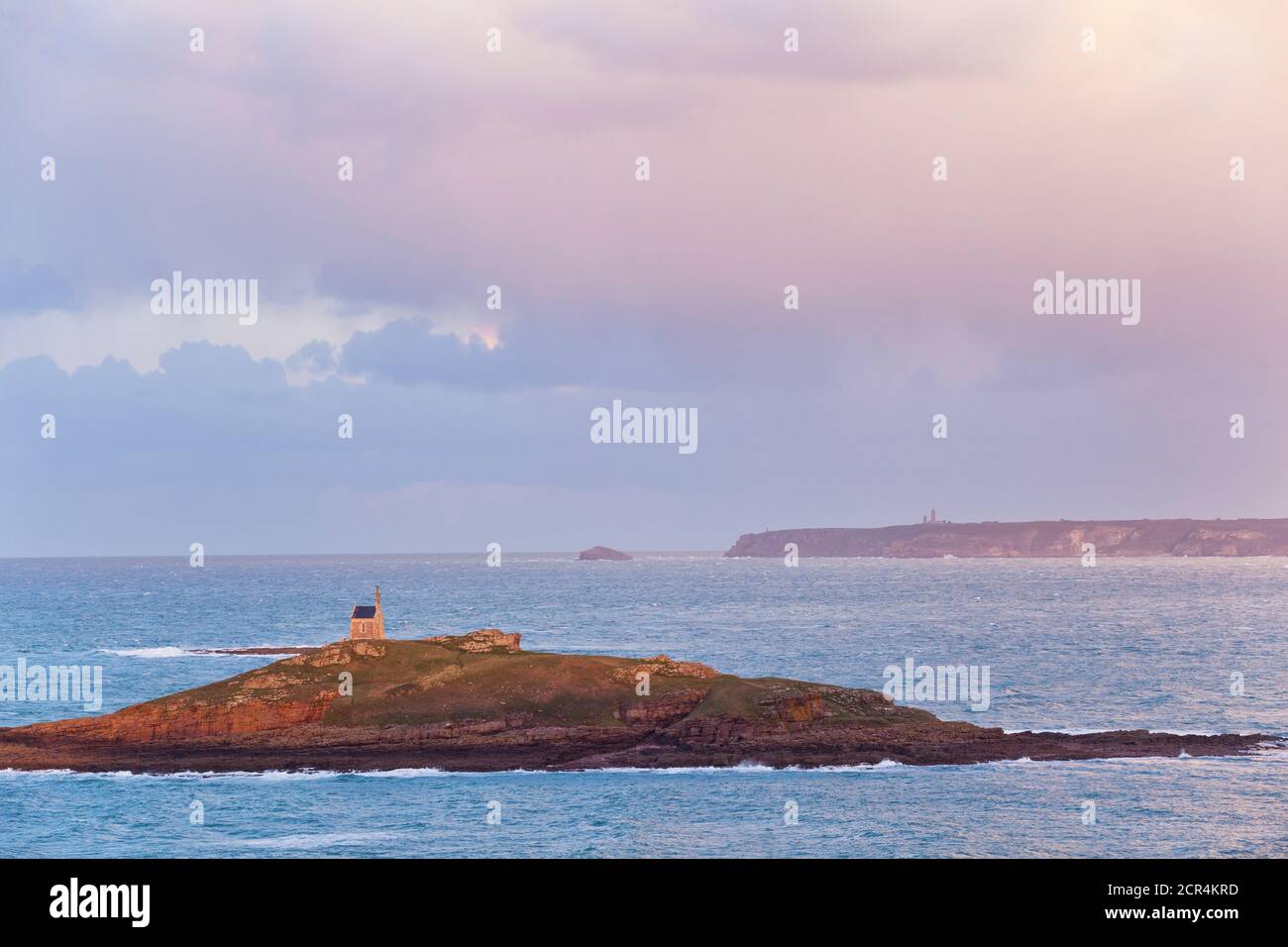 The tidal island of Ilot St. Michel at high tide with a view of Cap Frehel. Brittany, France Stock Photo