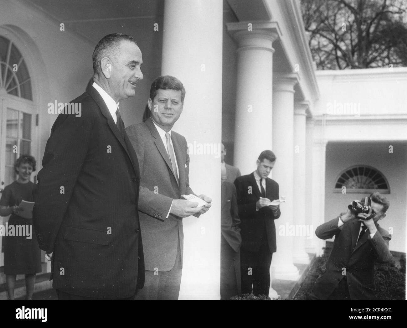President John F Kennedy and Vice-President Lyndon B Johnson meet with the press in the White House Rose Garden after Kennedy signed Executive Order 10925 requiring government contractors to treat all qualified employees equally 'without regard to their race, creed, color or national origin,' Washington, DC, 03/06/1961. (Photo by Abbie Rowe/RBM Vintage Images) Stock Photo