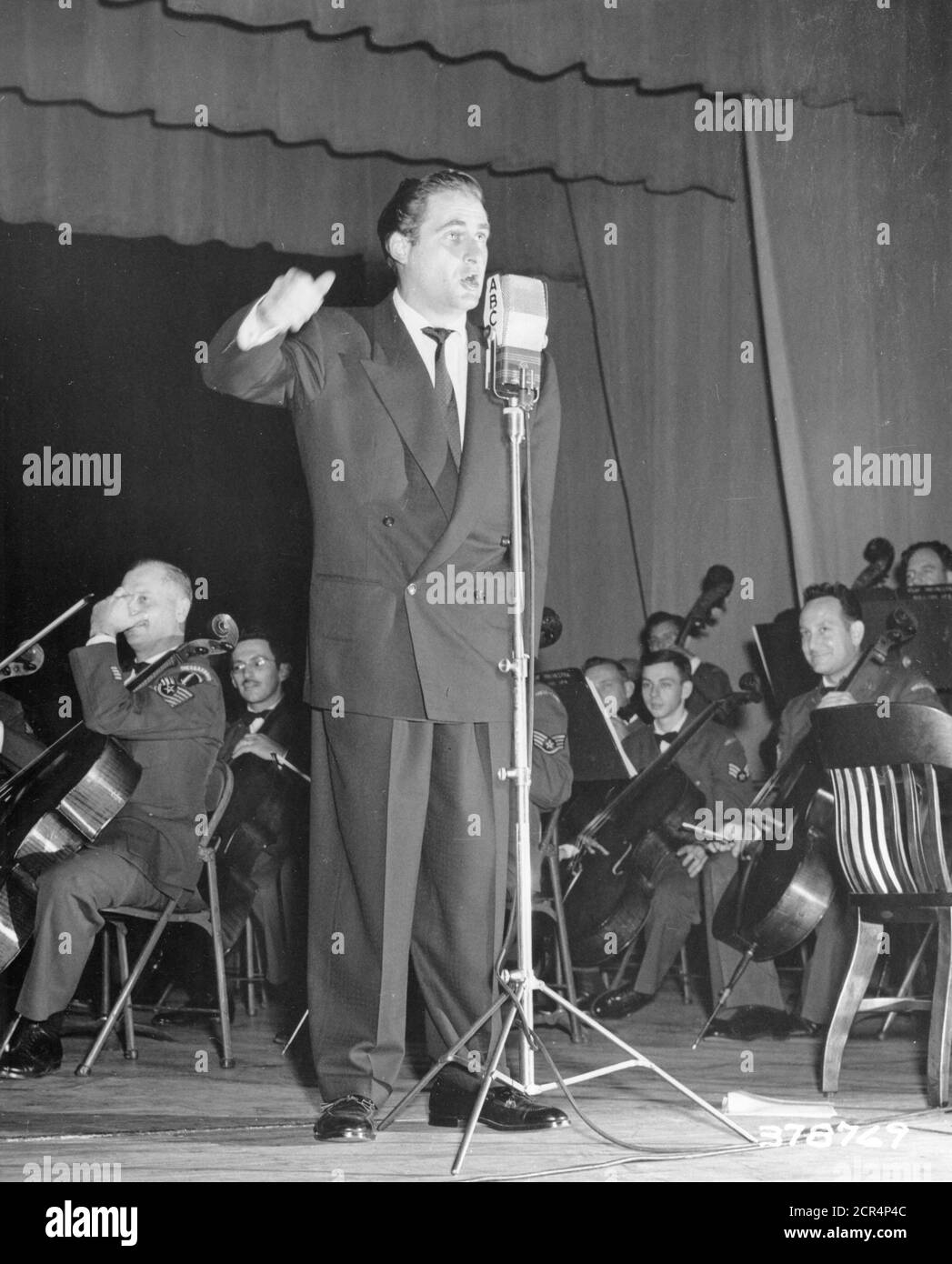 Sid Caesar, former Coast Guardsman and top TV headliner, performs at 'Time for Defense,' a weekly combination entertainment and documentary show produced by the Department of Defense and broadcasted by the American Broadcasting Company, Washington, DC, 01/1951. (Photo by Department of Defense/RBM Vintage Images) Stock Photo