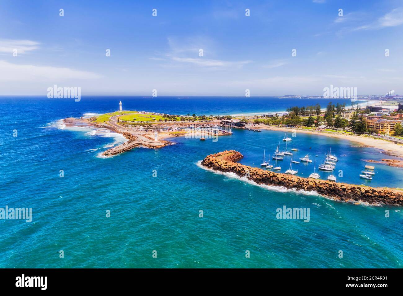 Aerial view of Wollongong city harbour with lighthouses and breakwater wall protecting marina and beaches. Stock Photo