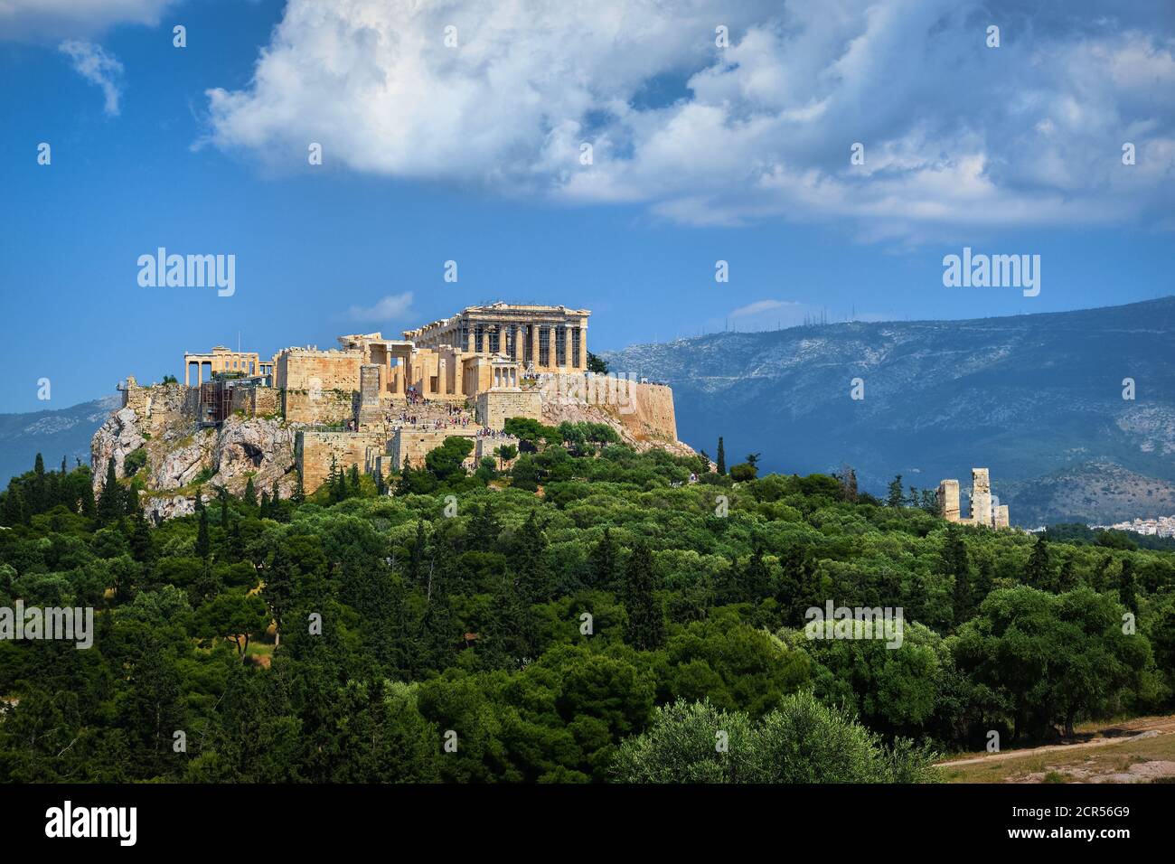 Great view of Acropolis hill from Pnyx hill on summer day with great clouds in blue sky, Athens, Greece. UNESCO world heritage. Propylaea, Parthenon. Stock Photo