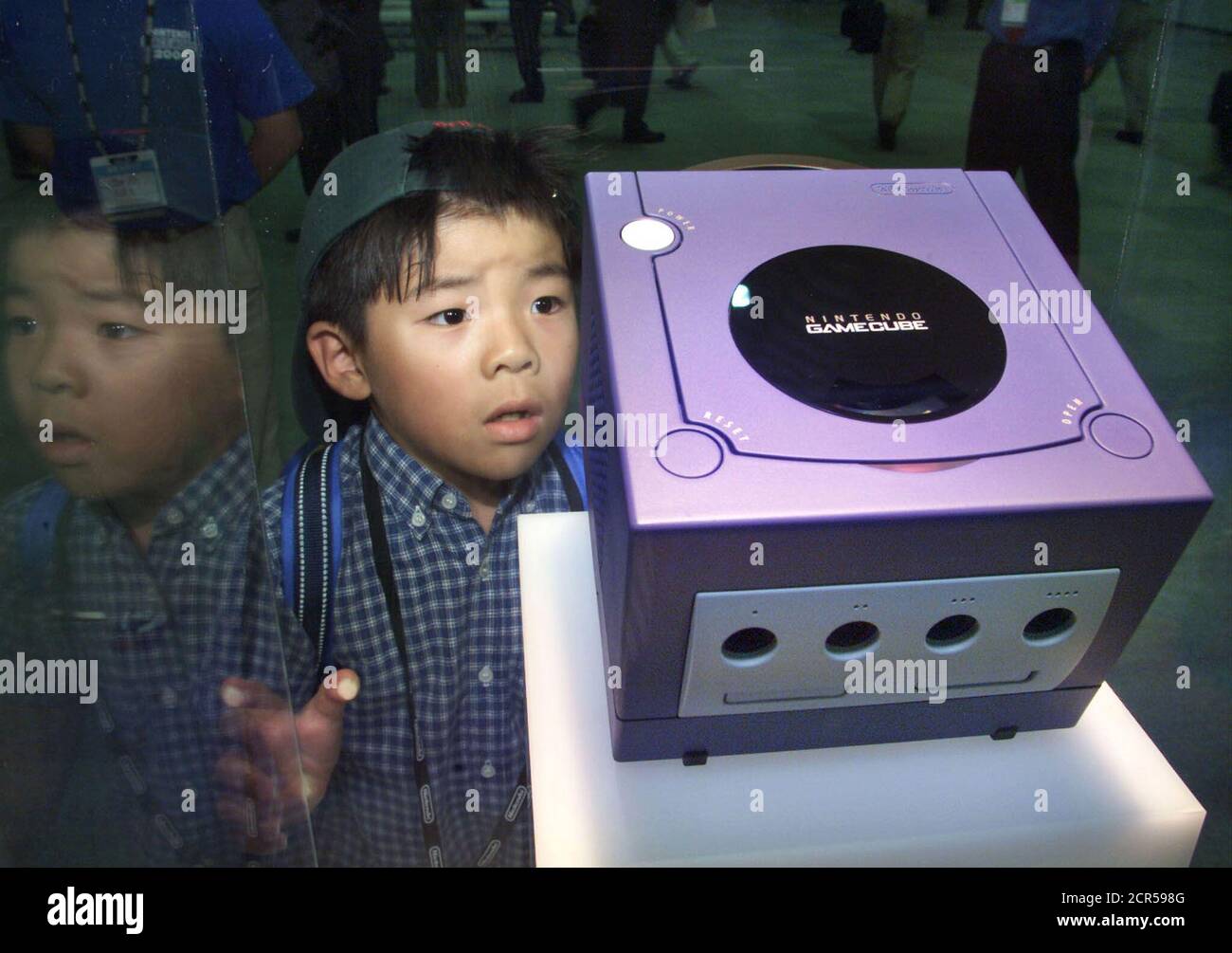 Seven-year-old Tsubasa Araki gazes at Gamecube on display at Nintendo Space  World 2000 in Makuhari August 24, 2000. Nintendo Co on Thursday became the  last of Japan's big game machine makers to