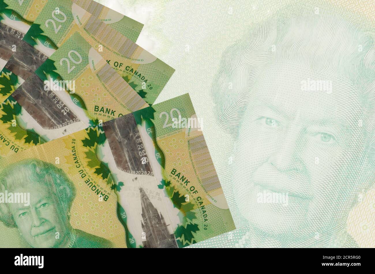 Stack Canadian $20 20 Canadian dollars bills lies in stack on background of big semi ...